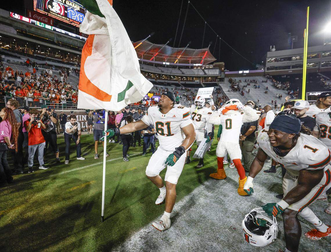 Miami Hurricanes offensive lineman Francis Mauigoa (61) plants the flag into the turf to celebrate the win after the Hurricanes defeat the Florida State Seminoles during their NCAA game at Doak Campbell Stadium in Tallahassee, Florida, on Saturday, October 4, 2025.